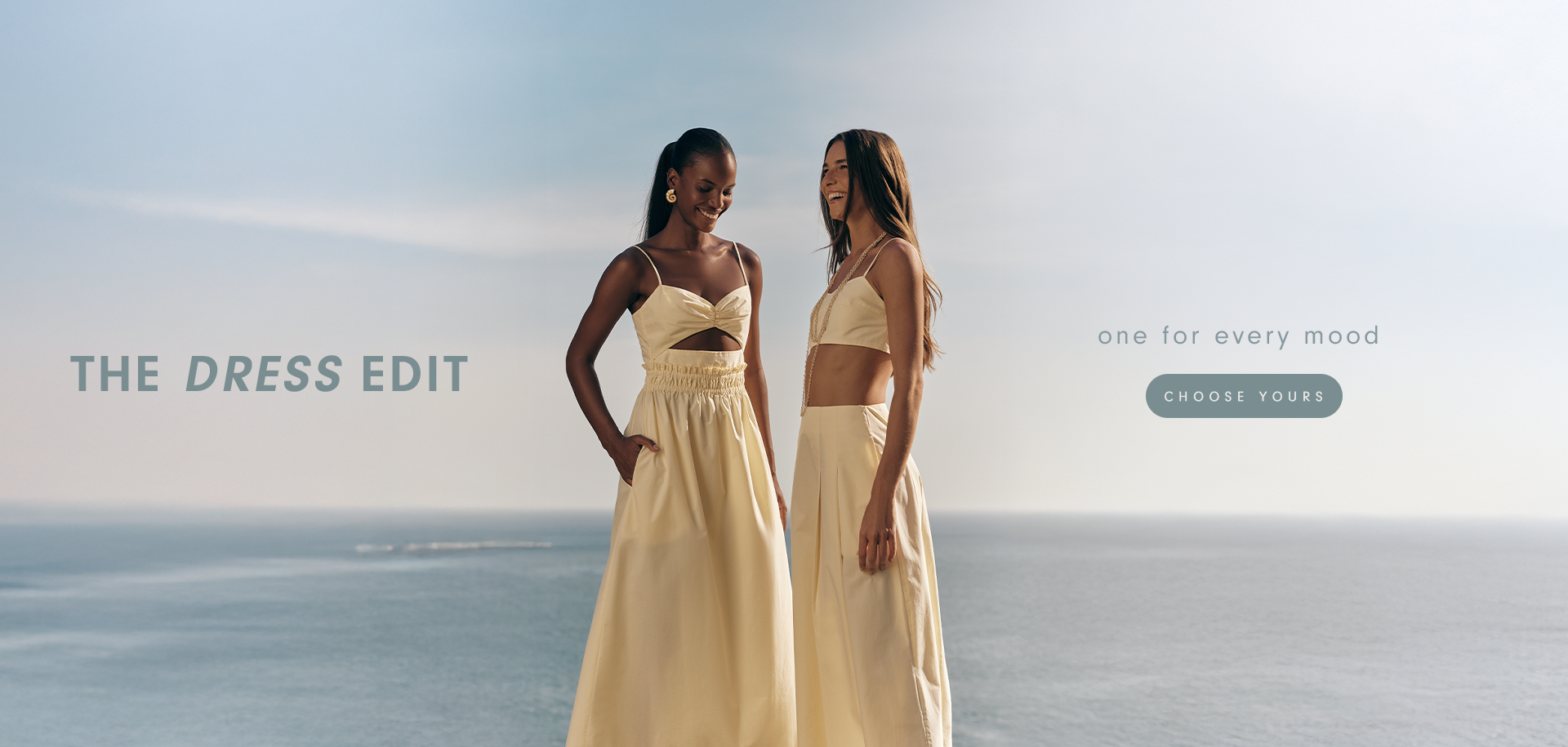 Two women standing side by side wearing light yellow dresses, with the ocean in the background. The text 'THE DRESS EDIT' is prominently displayed above, with the tagline 'one for every mood' and a 'Choose Yours' button