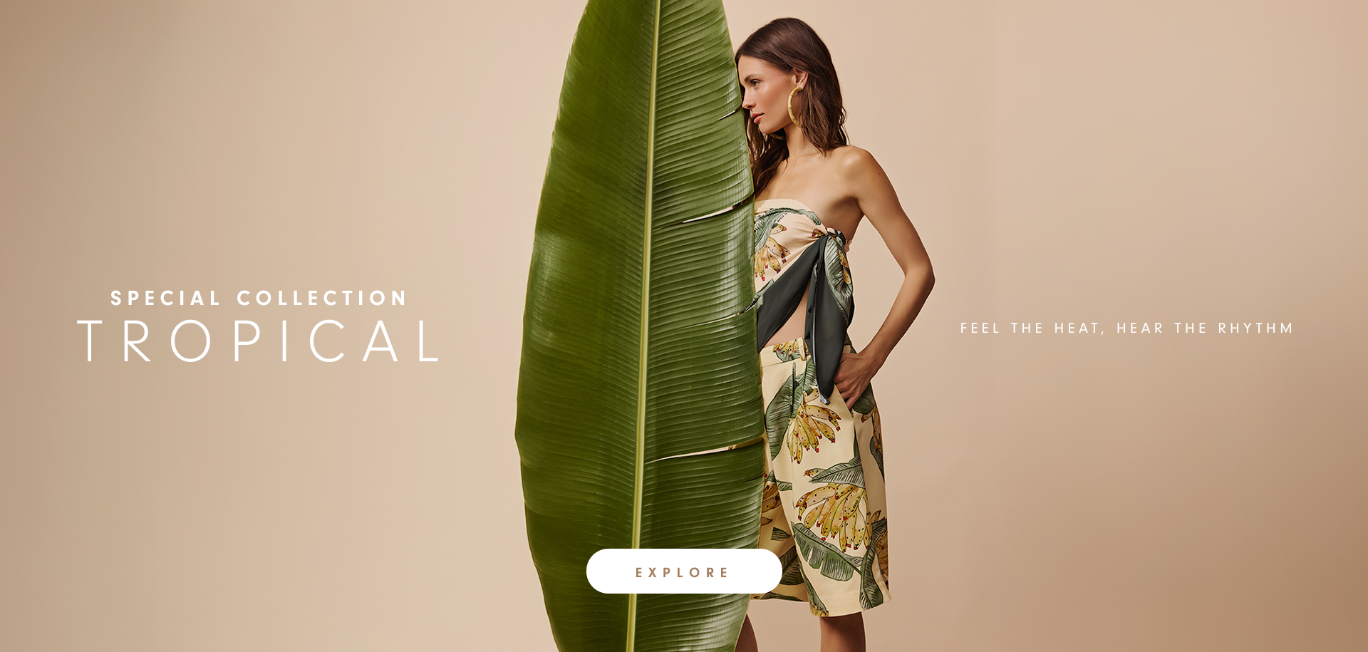 Banner from the Special Collection Tropical, featuring a model wearing a tropical leaf-print romper and holding a large palm leaf against a beige background. On the right, the text reads "Taking Rio’s lifestyle around the world", with an "Explore" button at the bottom.