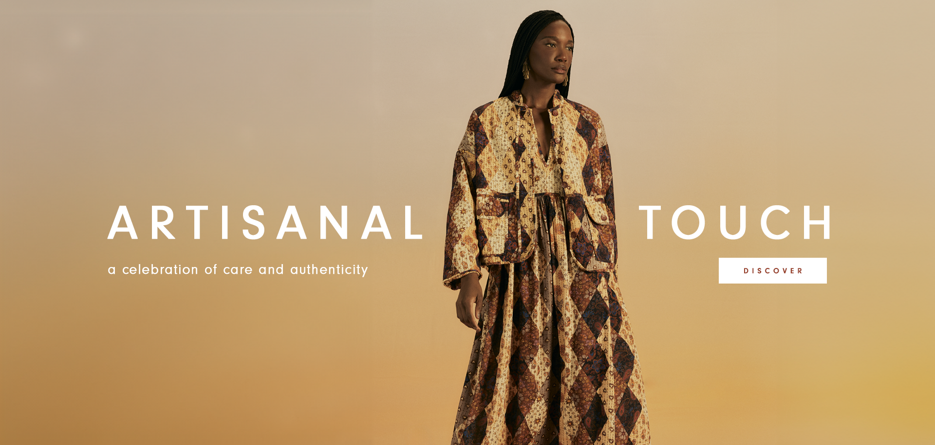 Orange background banner featuring a Black model with braided hair at the center, wearing a handcrafted dress with earthy-toned prints and a matching jacket in the same color and pattern. On the left side, the text reads "Artisanal: A Celebration of Care and Authenticity," and to the model's right, "TOUCH." Below, a button displays "DISCOVER.