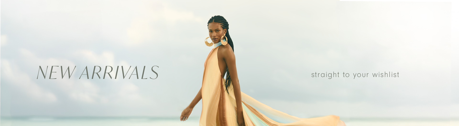 Elegant woman walking on the beach wearing a flowing, pastel-toned dress. The text 'New Arrivals' appears on the left and 'straight to your wishlist' on the right.