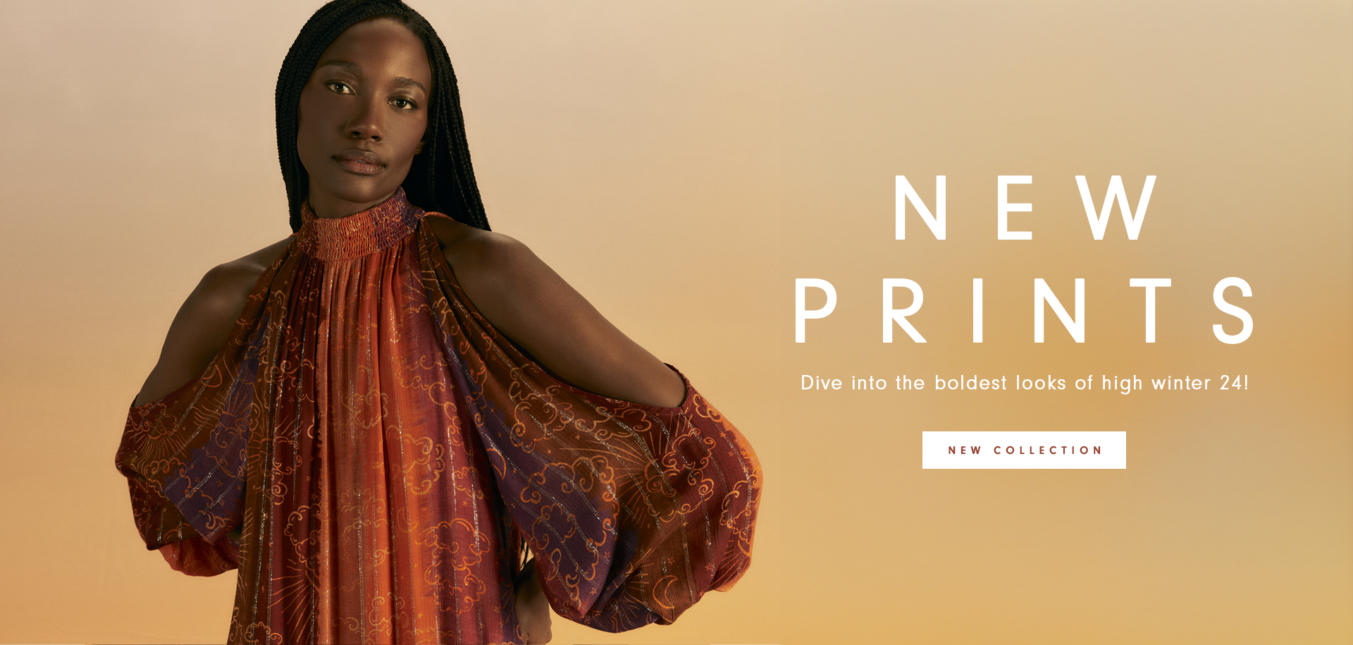 Banner with a gradient orange background. At the center, a Black model with long braided hair wears a flowy dress with open sleeves, featuring warm-toned prints in red and orange with golden details. On the right, the text "NEW PRINTS" appears in large white letters, followed by the phrase "Dive into the boldest looks of high winter 24!" in smaller font. Below, there is a button with the text "NEW COLLECTION."