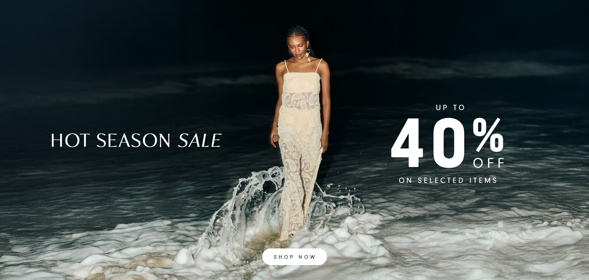 Woman walking by the shore at night, wearing a light, elegant dress. Text on the image reads: "Hot Season Sale – Up to 40% off on selected items".